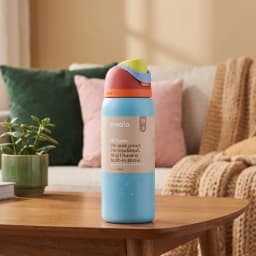 Light blue stainless steel insulated water bottle with a multi-color lid (red, orange, green, light blue) on a wooden table. - view 1