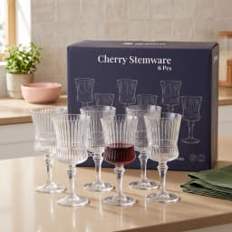 Dark blue box with white line drawings of six clear ribbed glass stemware glasses on a white background. - view 1