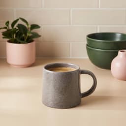 Single dark grey ceramic mug with a speckled texture and a C-shaped handle, on a white background. - view 1