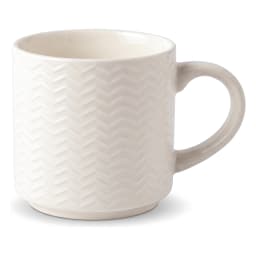 Single off-white ceramic mug with chevron pattern holding steaming coffee on a kitchen counter - view 2