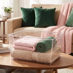 Clear rectangular acrylic storage bin with integrated handles and ribbed bottom, placed on a white shelf. - view 4
