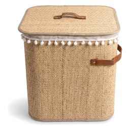 Tall, cylindrical beige khous laundry hamper with a lid, light grey fabric liner with white pom-poms, and brown faux leather… - view 3