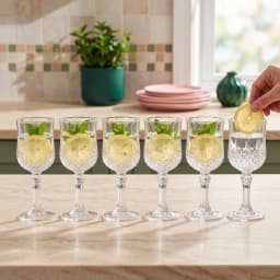 Set of 6 clear glass stemmed goblets with diamond cut pattern, shown on white background. - view 1