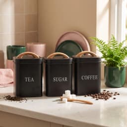 Matte black metal kitchen storage set with three small canisters labeled Sugar, Coffee, Tea, and a large bread box, all with… - view 5
