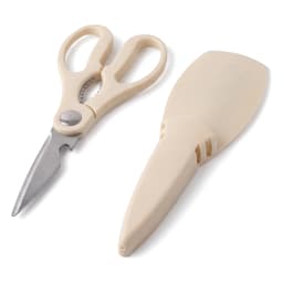 Beige silicone kitchen scissors with a matching protective sheath, lying on a white surface in a well-lit setting. - view 3