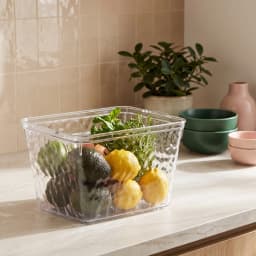 Clear rectangular acrylic storage box with a textured wavy pattern on a white shelf in a home setting. - view 1