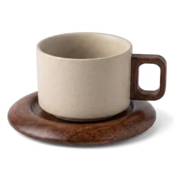 Beige speckled ceramic mug with dark wood handle on a round dark wood saucer, isolated on a white background. - view 3