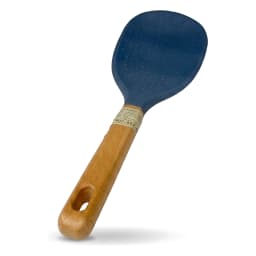 A single blue silicone rice paddle with a light brown wooden handle, resting on a clean white shelf. - view 2