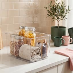 Clear rectangular acrylic storage basket with integrated handles on a white shelf - view 3