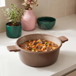 Taupe ceramic cooking pot with a clear glass lid and matching handles on a white background. - view 4