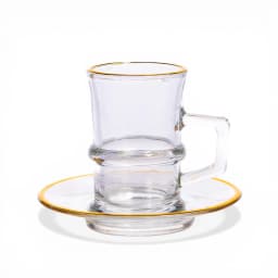 Clear glass mug with a handle and matching round glass saucer, both featuring a delicate gold rim, on a white background. - view 2