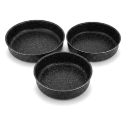 Set of three round black speckled granite baking dishes, stacked from largest to smallest, on a white surface. - view 3