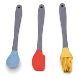 Three silicone kitchen utensils with grey handles and colorful heads: a blue spoon, a red spatula, and a yellow basting brus… - view 3