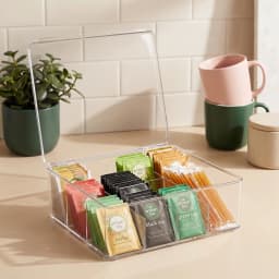 Clear acrylic storage box with a hinged lid and 12 compartments, filled with tea bags and coffee pods on a kitchen counter. - view 5