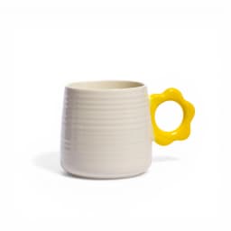 Cream ceramic mug with horizontal ridges and a bright yellow flower-shaped handle on a white background. - view 2