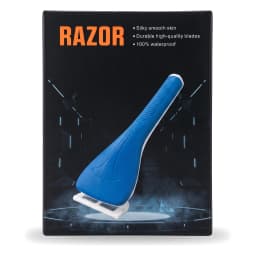 Blue manual razor in black packaging on a light beige bathroom counter next to a white sink and a green plant. - view 2