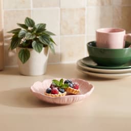 Pink glass flower-shaped dish with a darker pink and yellow center, shown on a white background. - view 4
