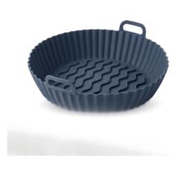 Round dark grey silicone air fryer liner with wavy bottom and fluted sides, featuring two small handles, on a white shelf. - view 2