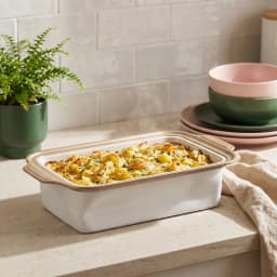Rectangular ceramic baking dish with light grey exterior, white interior, and brown rim on a white background - view 1