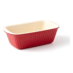 Red rectangular porcelain loaf pan with ribbed sides and cream interior on a white background. - view 2