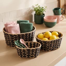 Set of three oval Khous storage baskets in black and natural beige woven pattern, stacked on a white background. - view 5