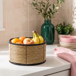 Single light brown woven natural fiber storage basket with black coiled trim on top and bottom edges, on a white background. - view 1