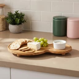 Light brown natural wood serving tray with two connected oval sections, elevated on small round feet, on a white background. - view 4