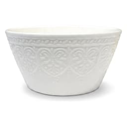Three white porcelain serving bowls with embossed design on a light brown wood stand, filled with snacks and dip. - view 2