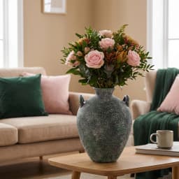 Single distressed green porcelain decorative vase with two small handles on a white background, showing textured finish. - view 3