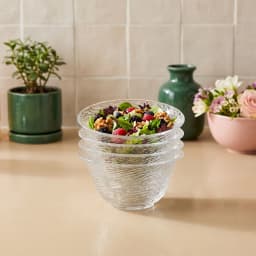 Stack of four clear textured glass serving bowls with a ribbed pattern on a white background - view 3