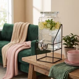 Clear rectangular glass beverage dispenser with an embossed design, silver spigot, and black metal stand on a white backgrou… - view 4