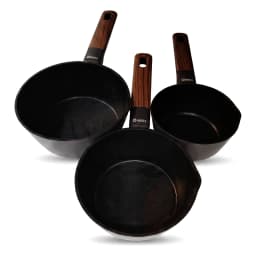 Set of three black ceramic saucepans with dark wood-look handles on a white kitchen counter, two filled with food. - view 2
