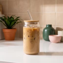 Clear glass tumbler with gold heart pattern, bamboo lid, and clear glass straw on a white background. - view 1
