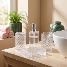 Four-piece clear acrylic bathroom set with diamond texture including a soap dispenser, toothbrush holder, cup, and soap dish. - view 1