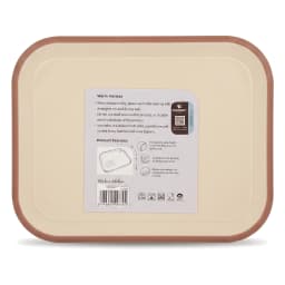 Cream plastic cutting board with pink trim, holding chopped bell peppers, cucumber, onion, and parsley on a kitchen counter. - view 3