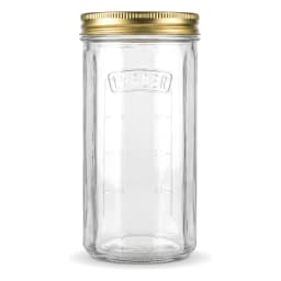 Four clear glass cylindrical storage jars with gold metal lids on a kitchen counter, filled with jam, pasta, and spices. - view 3