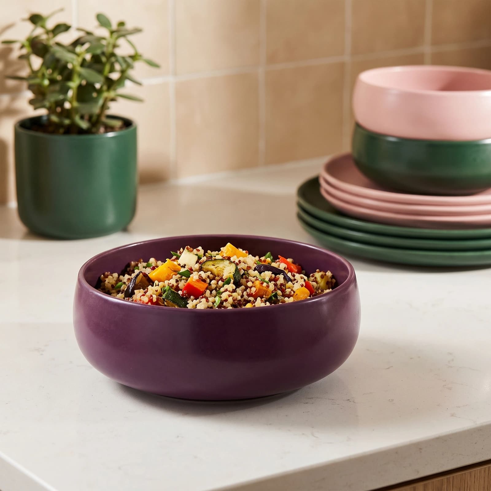 Single round deep plum ceramic serving bowl with a matte finish on a white background