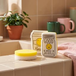 Set of yellow and white kitchen sponges, including round and shaped sponges like a mason jar with 'GOOD SMILE' text. - view 1