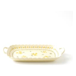 Cream porcelain serving tray with yellow floral design and wavy edges, holding appetizers, grapes, and cheese on a kitchen c… - view 3