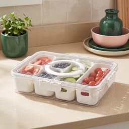 Clear rectangular plastic food storage container with white plastic dividers, filled with fresh strawberries, blueberries, c… - view 1