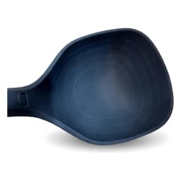 Single dark blue silicone ladle with a ribbed handle and hanging hole, standing upright on a white shelf. - view 3