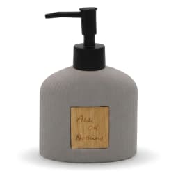 Grey speckled ceramic soap dispenser with a black pump and a light wooden label engraved with 'ALL OK Nothing' on a white ba… - view 3