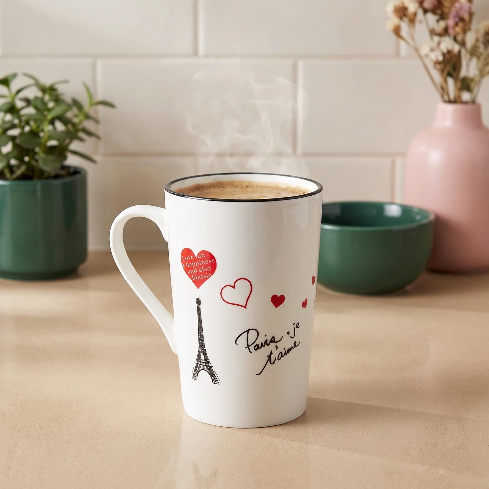 White ceramic mug with black rim, featuring a black Eiffel Tower, red hearts, and 'Paris je t'aime' text on a white backgrou…