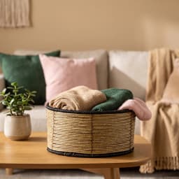 Single light brown woven natural fiber storage basket with black coiled trim on top and bottom edges, on a white background. - view 3