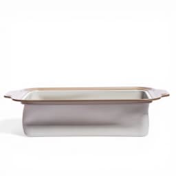 Rectangular ceramic baking dish with light grey exterior, white interior, and brown rim on a white background - view 2