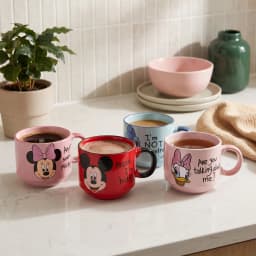Four assorted ceramic mugs with Disney characters: Minnie Mouse (pink), Mickey Mouse (red), Goofy (light blue), Daisy Duck (… - view 1