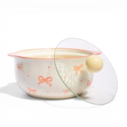 Cream ceramic serving bowl with coral bows and a clear glass lid with a yellow knob, filled with hot vegetable soup, on a wh… - view 3