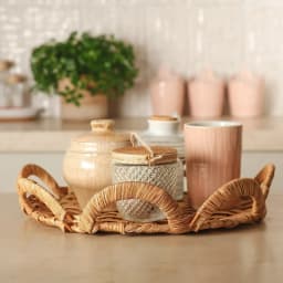 Light brown natural wicker serving tray with decorative scalloped edges on a white background - view 1