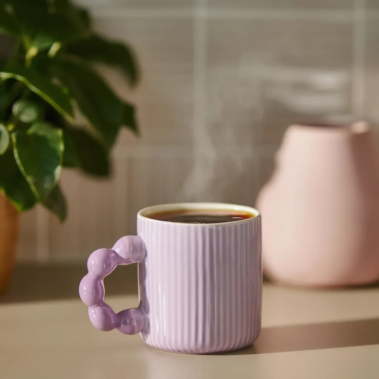 Single light purple ceramic mug with vertical ridges and a unique bubble-shaped handle, on a white background.