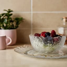 Clear textured glass serving bowl and rectangular plate with irregular wavy gold rims on a white background - view 1